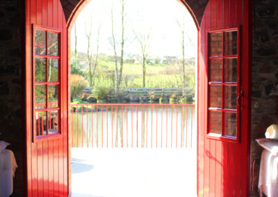 The Arches at Riverdale Barn doors open looking out into the pond